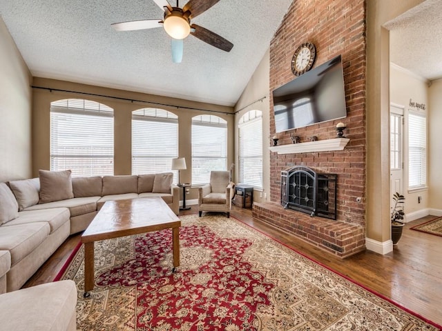 3968 Valez Dr, Carrollton, TX 75007 - living room featuring a textured ceiling, ceiling fan, plenty of natural light, wood finished floors, and a fireplace