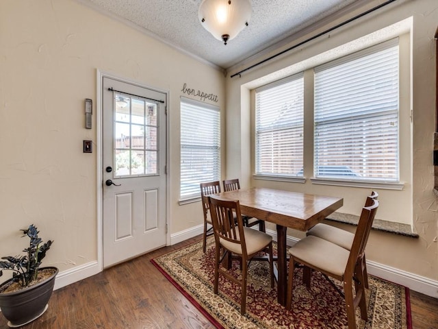 3968 Valez Dr, Carrollton, TX 75007 - dining space with wood finished floors, a textured ceiling, and baseboards