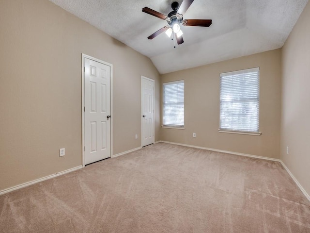 3968 Valez Dr, Carrollton, TX 75007 - unfurnished bedroom with carpet flooring, baseboards, lofted ceiling, multiple closets, and a ceiling fan