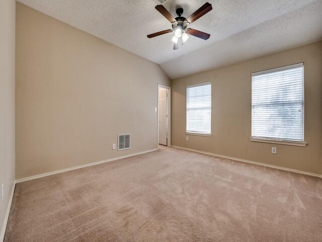 3968 Valez Dr, Carrollton, TX 75007 - unfurnished room with light carpet, baseboards, a ceiling fan, vaulted ceiling, and a textured ceiling