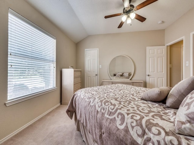 3968 Valez Dr, Carrollton, TX 75007 - bedroom featuring light colored carpet, multiple windows, baseboards, lofted ceiling, and ceiling fan
