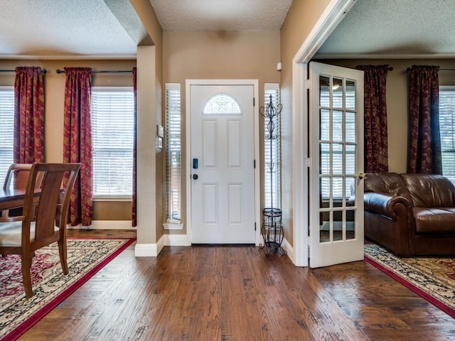 3968 Valez Dr, Carrollton, TX 75007 - entrance foyer with a textured ceiling, baseboards, and wood finished floors