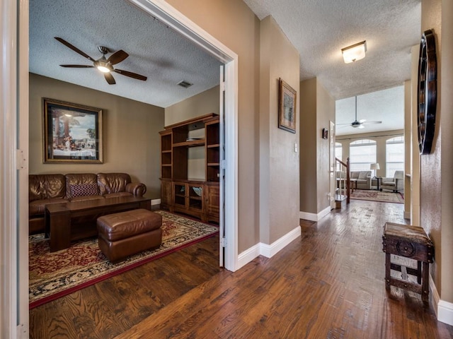 3968 Valez Dr, Carrollton, TX 75007 - living room with ceiling fan, a textured ceiling, wood finished floors, and baseboards