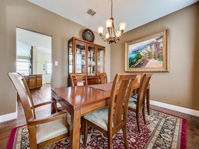 3968 Valez Dr, Carrollton, TX 75007 - dining space with a chandelier, baseboards, and wood finished floors