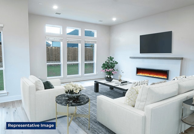 5212 Deep Creek Dr, Fort Worth, TX 76179 - living room featuring a lit fireplace, wood finished floors, baseboards, and recessed lighting