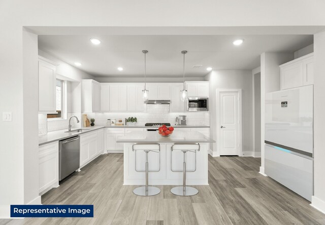 5212 Deep Creek Dr, Fort Worth, TX 76179 - kitchen featuring stainless steel appliances, backsplash, a center island, white cabinetry, and recessed lighting