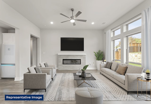 5212 Deep Creek Dr, Fort Worth, TX 76179 - living room with wood finished floors, ceiling fan, a glass covered fireplace, recessed lighting, and baseboards