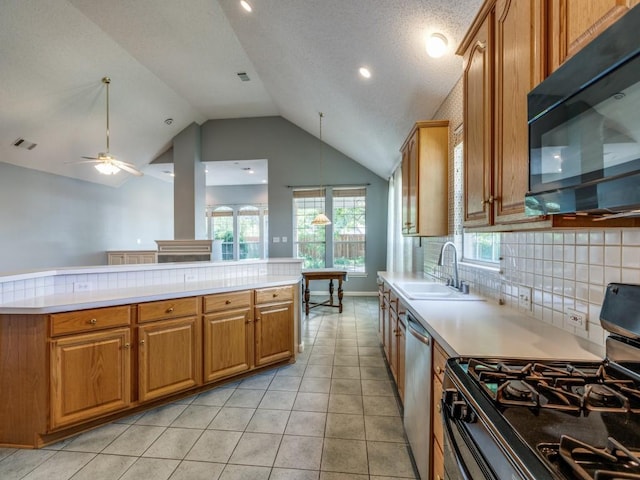 2614 Tourette Ct, Mckinney, TX 75070 - kitchen featuring black microwave, gas range oven, dishwasher, lofted ceiling, and light countertops