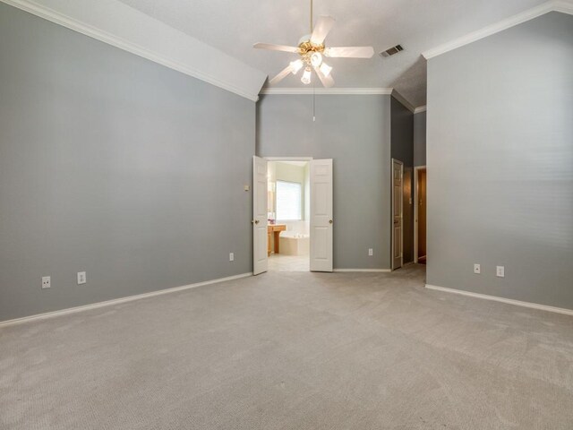 2614 Tourette Ct, Mckinney, TX 75070 - spare room with a ceiling fan, high vaulted ceiling, light carpet, ornamental molding, and baseboards