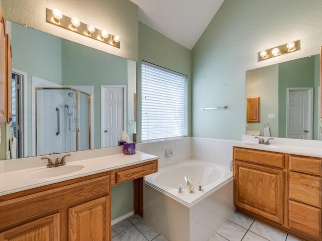 2614 Tourette Ct, Mckinney, TX 75070 - bathroom with lofted ceiling, a stall shower, vanity, tile patterned floors, and a garden tub