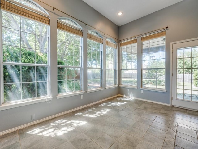 2614 Tourette Ct, Mckinney, TX 75070 - unfurnished sunroom featuring plenty of natural light, tile patterned floors, and baseboards