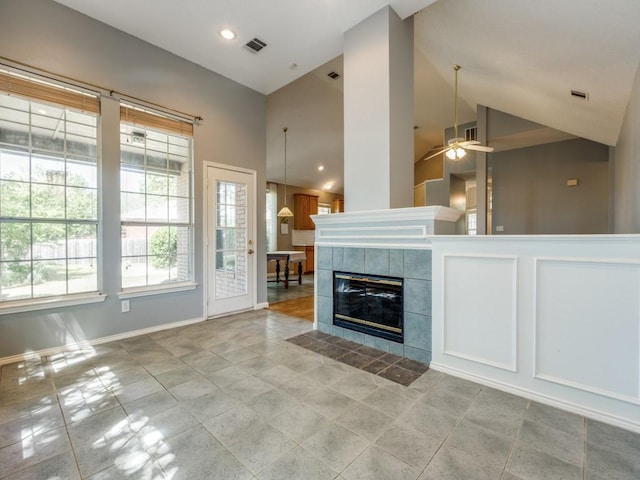 2614 Tourette Ct, Mckinney, TX 75070 - unfurnished living room featuring a tile fireplace, a ceiling fan, baseboards, high vaulted ceiling, and recessed lighting