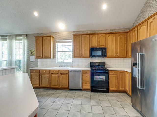 2614 Tourette Ct, Mckinney, TX 75070 - kitchen with black appliances, a sink, vaulted ceiling, light countertops, and backsplash