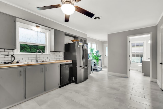 1316 Elm St, Bonham, TX 75418 - kitchen with dishwasher, gray cabinets, a sink, tasteful backsplash, and crown molding