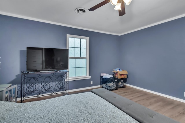 1316 Elm St, Bonham, TX 75418 - bedroom with baseboards, wood finished floors, crown molding, and a ceiling fan