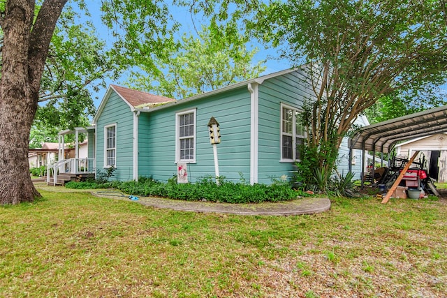 1316 Elm St, Bonham, TX 75418 - view of property exterior featuring a lawn and a detached carport