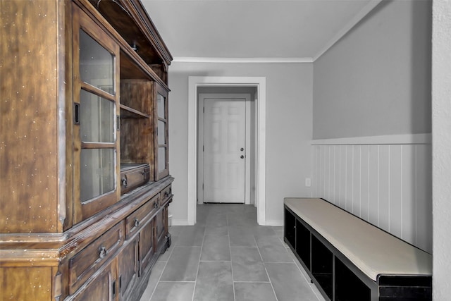 1316 Elm St, Bonham, TX 75418 - mudroom with ornamental molding, tile patterned floors, wainscoting, and baseboards