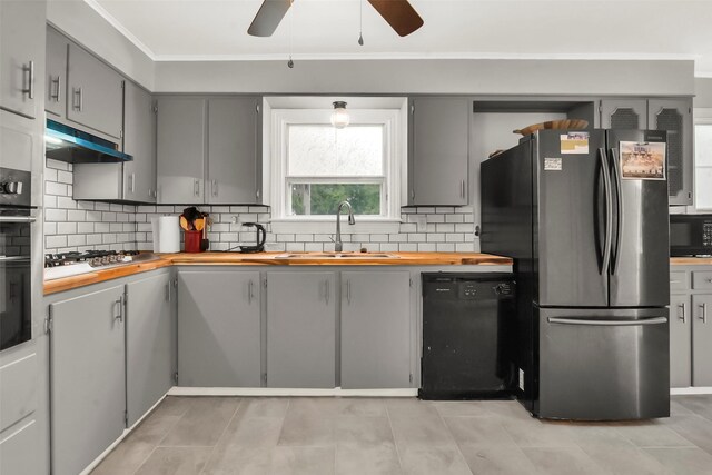 1316 Elm St, Bonham, TX 75418 - kitchen featuring black appliances, gray cabinetry, butcher block countertops, a sink, and under cabinet range hood