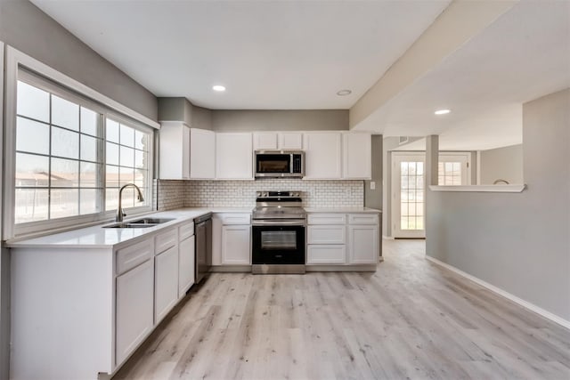4205 Longstraw Dr, Fort Worth, TX 76137 - kitchen featuring appliances with stainless steel finishes, tasteful backsplash, white cabinets, light countertops, and recessed lighting