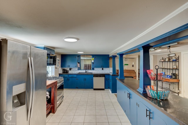 198 Main St, Doyline, LA 71023 - kitchen featuring stainless steel appliances, blue cabinetry, dark countertops, a sink, and light tile patterned floors
