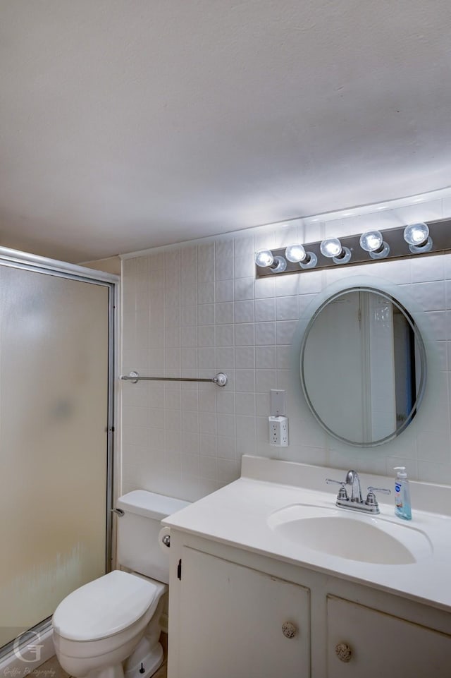 198 Main St, Doyline, LA 71023 - bathroom featuring vanity, toilet, a shower stall, and tile walls