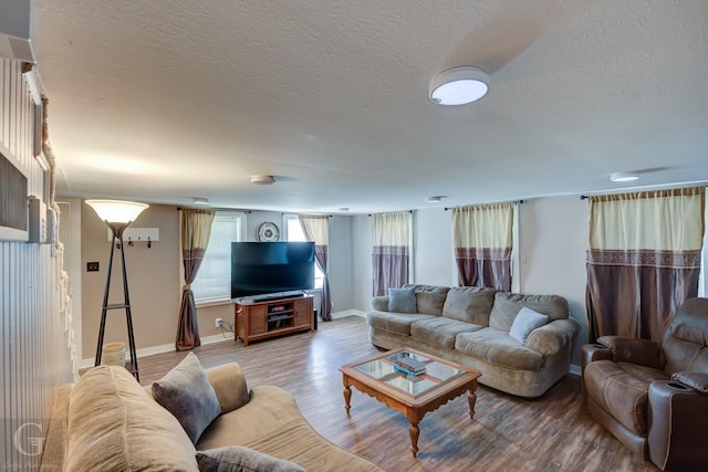 198 Main St, Doyline, LA 71023 - living area with light wood-style flooring, a textured ceiling, and baseboards