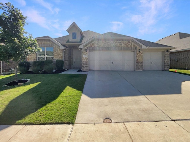 629 Brody Trl, Aledo, TX 76008 - view of front facade with stone siding, a garage, driveway, and a front lawn