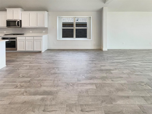 629 Brody Trl, Aledo, TX 76008 - kitchen with appliances with stainless steel finishes, open floor plan, light countertops, white cabinets, and baseboards