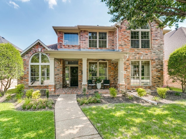 2270 Magic Mantle Dr, Lewisville, TX 75056 - view of front of house featuring covered porch, brick siding, and a front yard