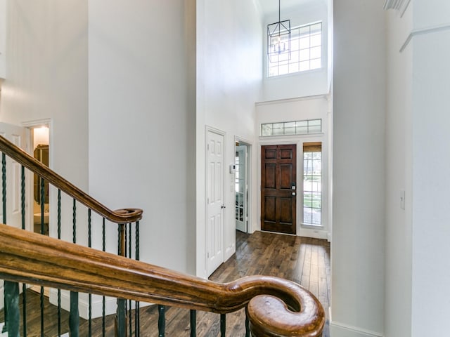 2270 Magic Mantle Dr, Lewisville, TX 75056 - foyer entrance with a towering ceiling, healthy amount of natural light, dark wood-type flooring, stairs, and baseboards