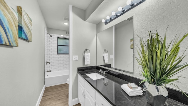 104 Shadowoak Ct, Burleson, TX 76028 - full bathroom featuring vanity, bathtub / shower combination, wood finished floors, toilet, and baseboards