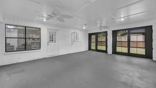 104 Shadowoak Ct, Burleson, TX 76028 - empty room featuring finished concrete flooring, a ceiling fan, and brick wall