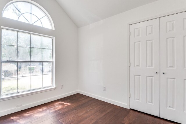 7405 Armstrong Ln, Rowlett, TX 75089 - unfurnished bedroom featuring vaulted ceiling, dark wood-style flooring, a closet, and baseboards