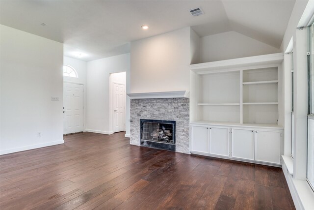 7405 Armstrong Ln, Rowlett, TX 75089 - unfurnished living room with dark wood-type flooring, a fireplace, lofted ceiling, and baseboards