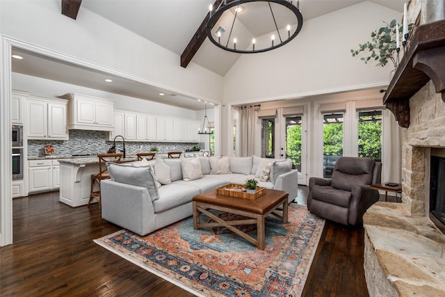 321 Hitch Wagon Dr, Mckinney, TX 75071 - living area with a chandelier, high vaulted ceiling, a fireplace, dark wood-type flooring, and beam ceiling