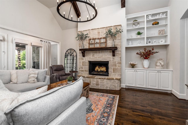 321 Hitch Wagon Dr, Mckinney, TX 75071 - living room with dark wood-type flooring, high vaulted ceiling, a chandelier, a fireplace, and baseboards