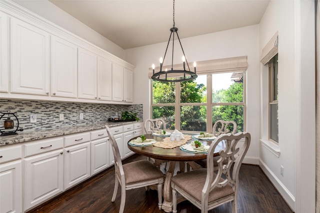 321 Hitch Wagon Dr, Mckinney, TX 75071 - dining space featuring dark wood-style floors, a chandelier, and baseboards