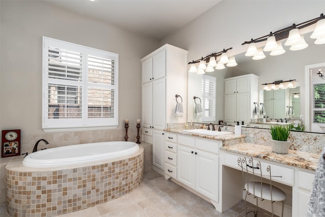 321 Hitch Wagon Dr, Mckinney, TX 75071 - full bathroom featuring plenty of natural light, a garden tub, vanity, and tile patterned floors