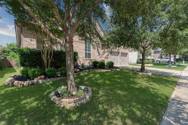 321 Hitch Wagon Dr, Mckinney, TX 75071 - obstructed view of property featuring driveway, brick siding, and a garage