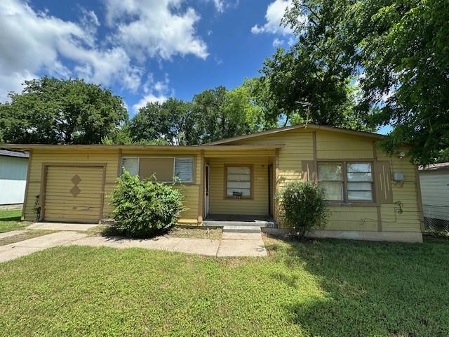 2915 56th St, Dallas, TX 75241 - ranch-style house with a front yard, concrete driveway, and an attached garage