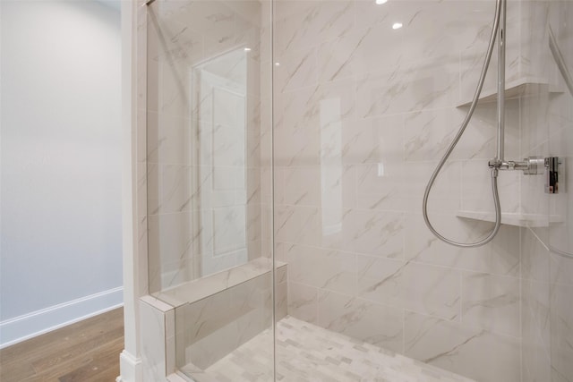 4651 New Water Ln, Dallas, TX 75219 - bathroom with a marble finish shower, wood finished floors, and baseboards