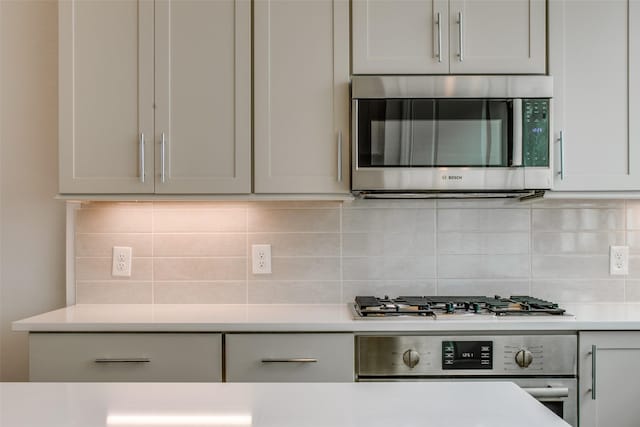 4651 New Water Ln, Dallas, TX 75219 - kitchen with stainless steel appliances, decorative backsplash, and light countertops