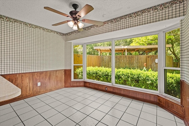 3601 University Dr, Garland, TX 75043 - unfurnished sunroom featuring a textured ceiling, wallpapered walls, and wood walls