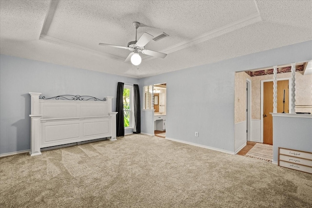 3601 University Dr, Garland, TX 75043 - unfurnished bedroom featuring a textured ceiling, a tray ceiling, carpet, baseboards, and ceiling fan