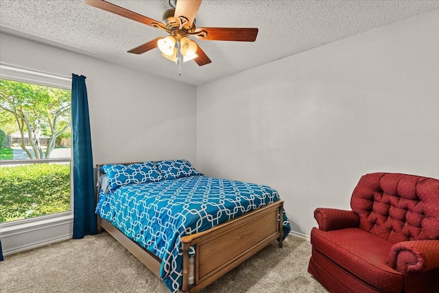 3601 University Dr, Garland, TX 75043 - bedroom featuring carpet flooring, a textured ceiling, ceiling fan, and baseboards