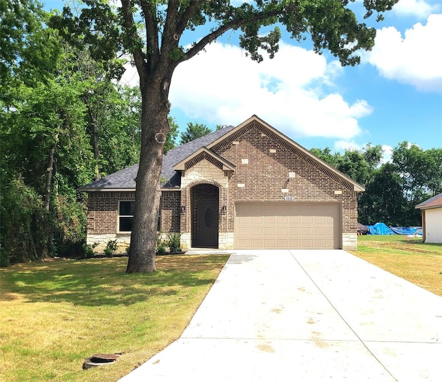 1820 Smoke Tree Ln, Dallas, TX 75253 - view of front of property with brick siding, concrete driveway, an attached garage, a front yard, and roof with shingles