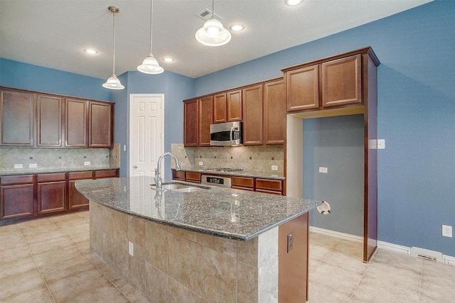 1213 Hackworth St, Roanoke, TX 76262 - kitchen with a sink, appliances with stainless steel finishes, dark stone countertops, backsplash, and recessed lighting