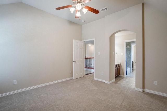 1213 Hackworth St, Roanoke, TX 76262 - unfurnished bedroom featuring arched walkways, light colored carpet, high vaulted ceiling, and baseboards