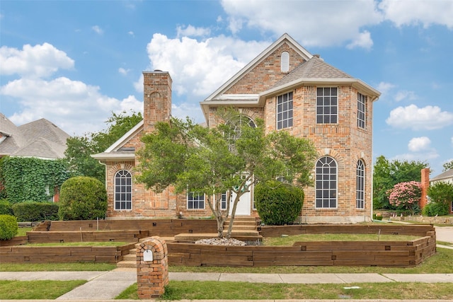 2300 Pagoda Oak Dr, Plano, TX 75074 - view of front of property with brick siding, a chimney, and a garden