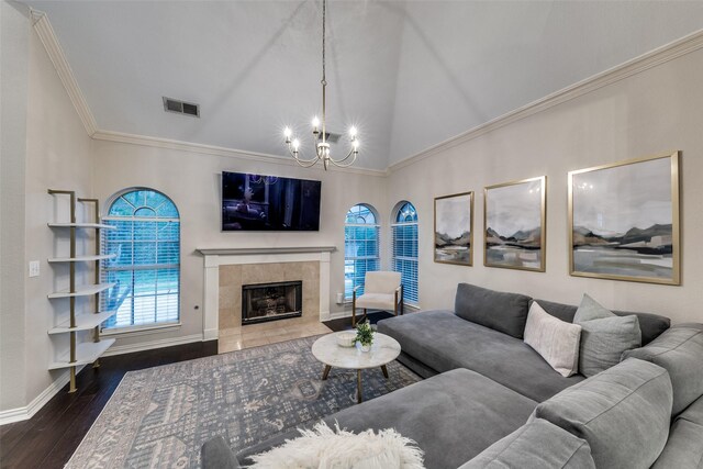2300 Pagoda Oak Dr, Plano, TX 75074 - living area featuring a chandelier, wood finished floors, healthy amount of natural light, a tiled fireplace, and ornamental molding